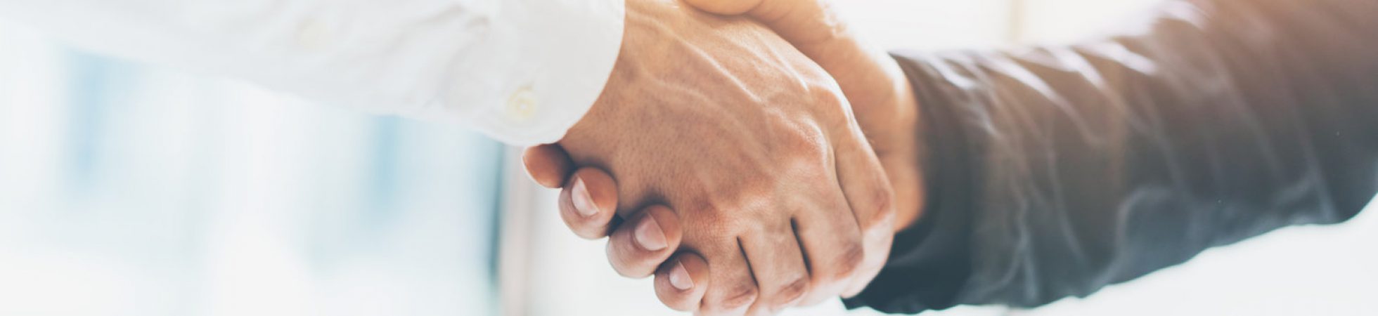 Business partnership meeting. Picture businessmans handshake. Successful businessmen handshaking after good deal. Horizontal, blurred